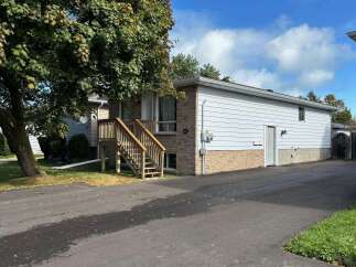 Charming home with a welcoming wooden staircase leading to the front door.