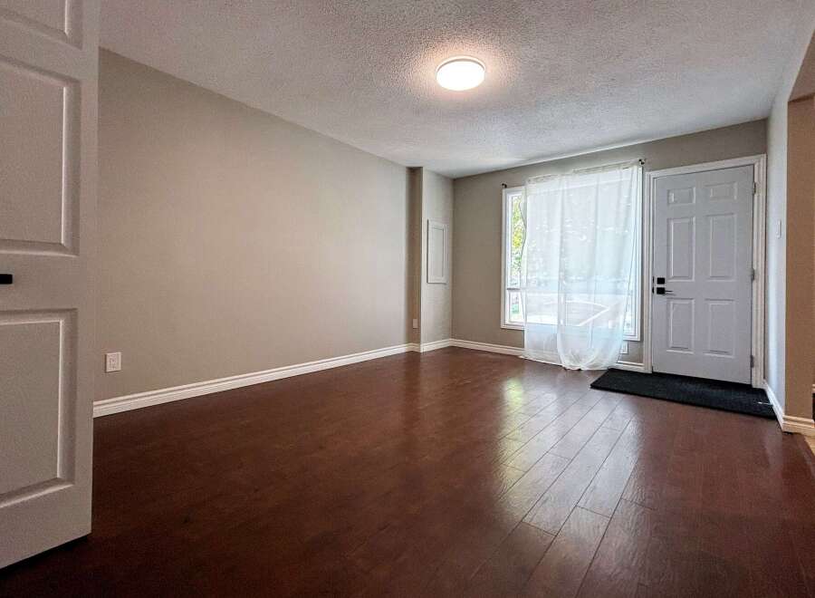 Step into this inviting space featuring beautiful hardwood floors and neutral walls, creating a warm and welcoming atmosphere.