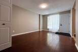 Step into this inviting space featuring beautiful hardwood floors and neutral walls, creating a warm and welcoming atmosphere.