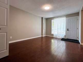 Step into this inviting space featuring beautiful hardwood floors and neutral walls, creating a warm and welcoming atmosphere.