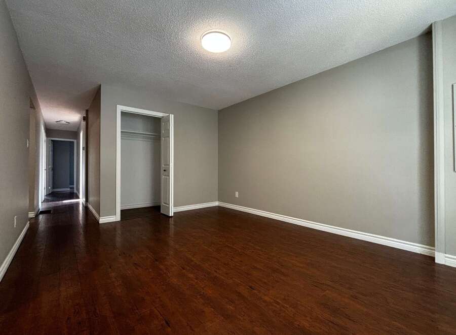 Step into this inviting space featuring beautiful hardwood floors and neutral walls, creating a warm and versatile atmosphere.