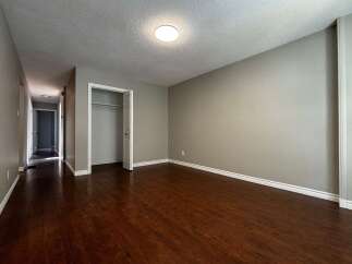 Step into this inviting space featuring beautiful hardwood floors and neutral walls, creating a warm and versatile atmosphere.