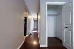 Step into this inviting hallway, showcasing beautiful hardwood floors that extend throughout the space.
