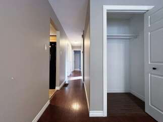 Step into this inviting hallway, showcasing beautiful hardwood floors that extend throughout the space.