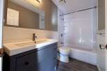 This bathroom features a modern vanity with ample storage and a sleek design.