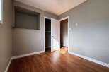 Step into this inviting room featuring warm wood flooring and neutral walls, creating a versatile space ready for your personal touch.