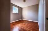 This inviting room features a warm, inviting atmosphere with its rich, wood-look flooring and neutral wall colors.