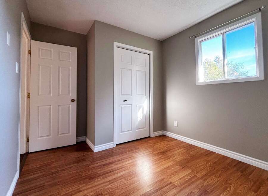Step into this inviting room, featuring a neutral color palette that complements the warm wood flooring.