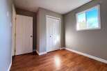 Step into this inviting room, featuring a neutral color palette that complements the warm wood flooring.
