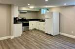 This kitchen features a modern design with sleek white cabinetry and a stainless steel oven.