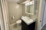 This charming bathroom features a stylish vanity with a sleek sink and ample storage.