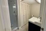 This bathroom features a modern design with a sleek shower enclosure and a stylish vanity.