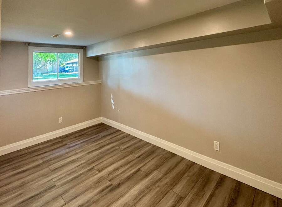 This inviting room features a neutral color palette, creating a versatile space ready for your personal touch.