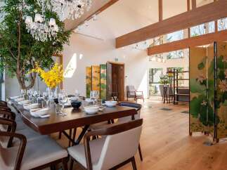Experience luxury living in this stunning property, featuring a spacious dining area perfect for entertaining.