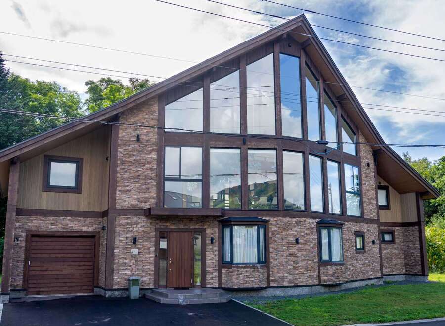 This stunning property boasts a unique architectural design with a striking A-frame structure and expansive windows that flood the interior with natural light.