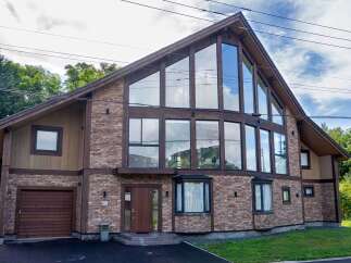This stunning property boasts a unique architectural design with a striking A-frame structure and expansive windows that flood the interior with natural light.