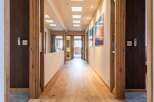Step into luxury with this stunning hallway, showcasing exquisite wooden flooring and elegant door frames.