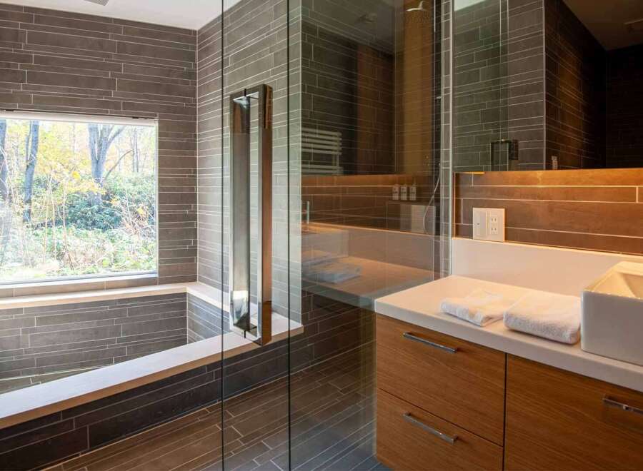 This modern bathroom boasts a sleek design with a walk-in shower and a luxurious soaking tub.