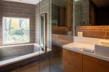 This modern bathroom boasts a sleek design with a walk-in shower and a luxurious soaking tub.