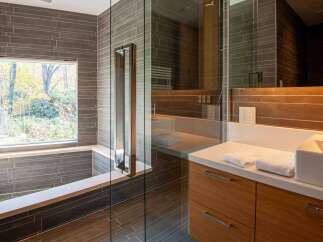 This modern bathroom boasts a sleek design with a walk-in shower and a luxurious soaking tub.