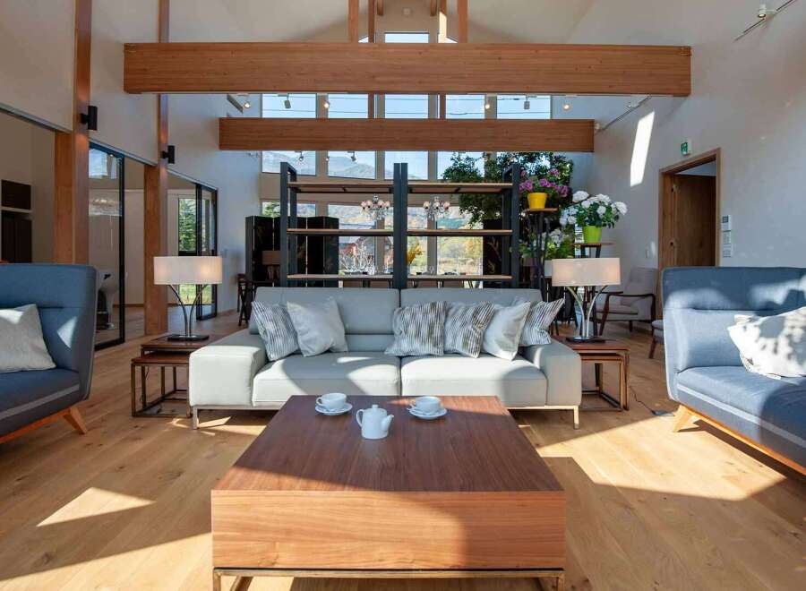 Experience luxury living in this stunning property, featuring a spacious living room with high ceilings and natural light.