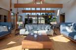 Experience luxury living in this stunning property, featuring a spacious living room with high ceilings and natural light.