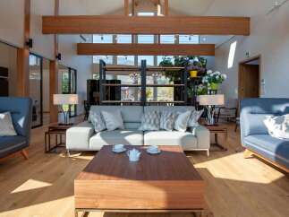 Experience luxury living in this stunning property, featuring a spacious living room with high ceilings and natural light.