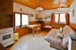 Discover the charm of this cozy property! Featuring a warm, inviting interior with wooden paneling and a functional layout.