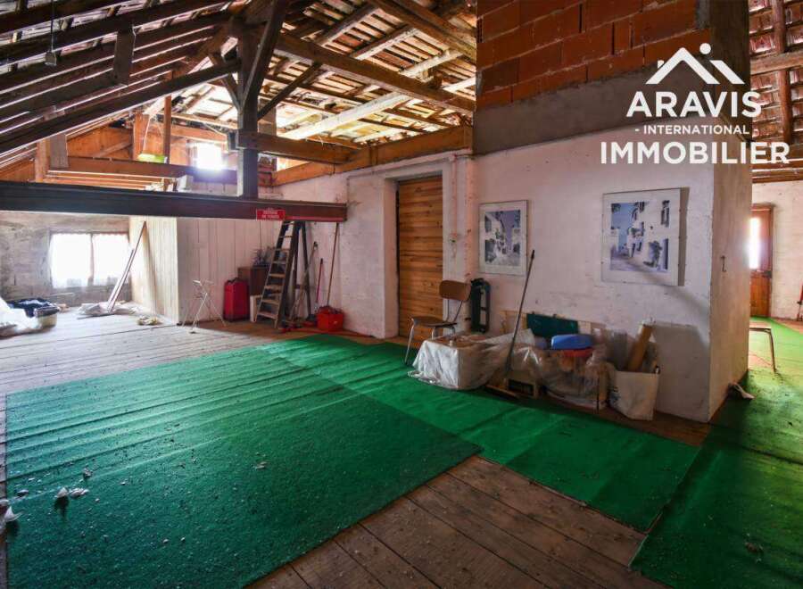 Discover the potential of this unique property, featuring a spacious interior with exposed wooden beams and a rustic charm.