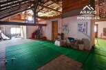 Discover the potential of this unique property, featuring a spacious interior with exposed wooden beams and a rustic charm.