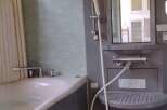 This modern bathroom features a sleek design with a combination of gray and white elements.