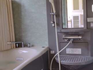 This modern bathroom features a sleek design with a combination of gray and white elements.