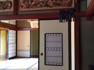 Step into a serene Japanese-style home with intricate wooden carvings and traditional sliding doors.