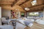 This luxurious living space showcases a stunning blend of rustic charm and modern elegance.