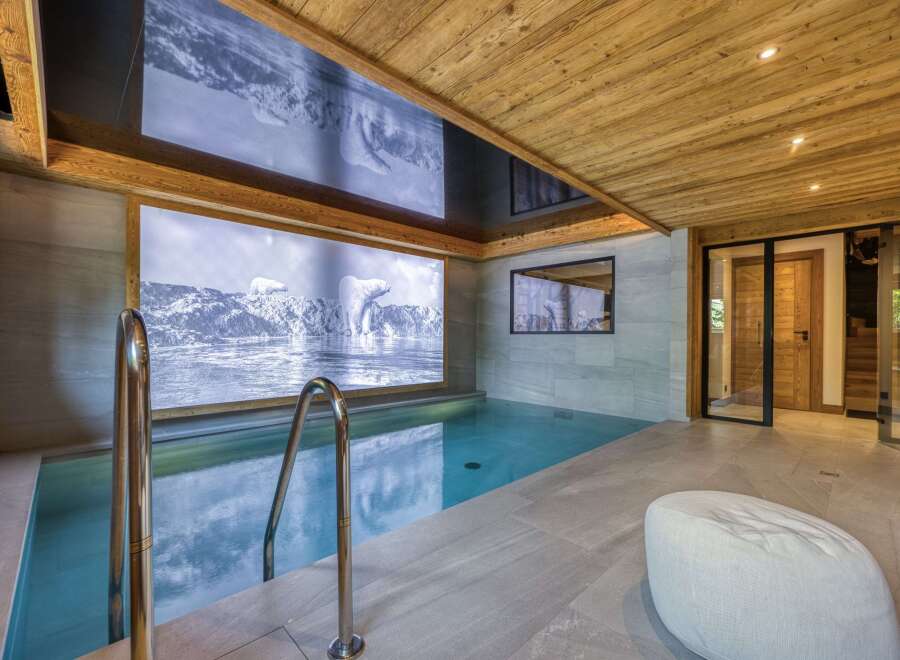 Indulge in luxury with this stunning indoor pool, featuring a captivating polar bear mural that transports you to a serene winter wonderland.