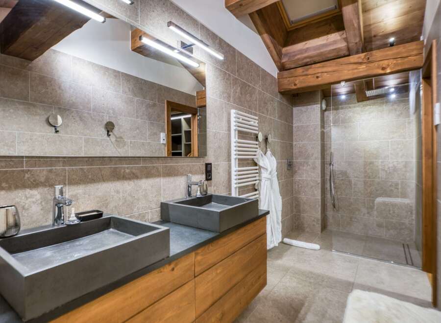 This luxurious bathroom features a modern design with a touch of rustic charm.