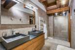 This luxurious bathroom features a modern design with a touch of rustic charm.