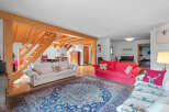 This stunning property boasts a spacious living area with exposed wooden beams, creating a warm and inviting atmosphere.