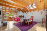 This charming property boasts a unique architectural design with exposed wooden beams and a skylight, creating a warm and inviting atmosphere.