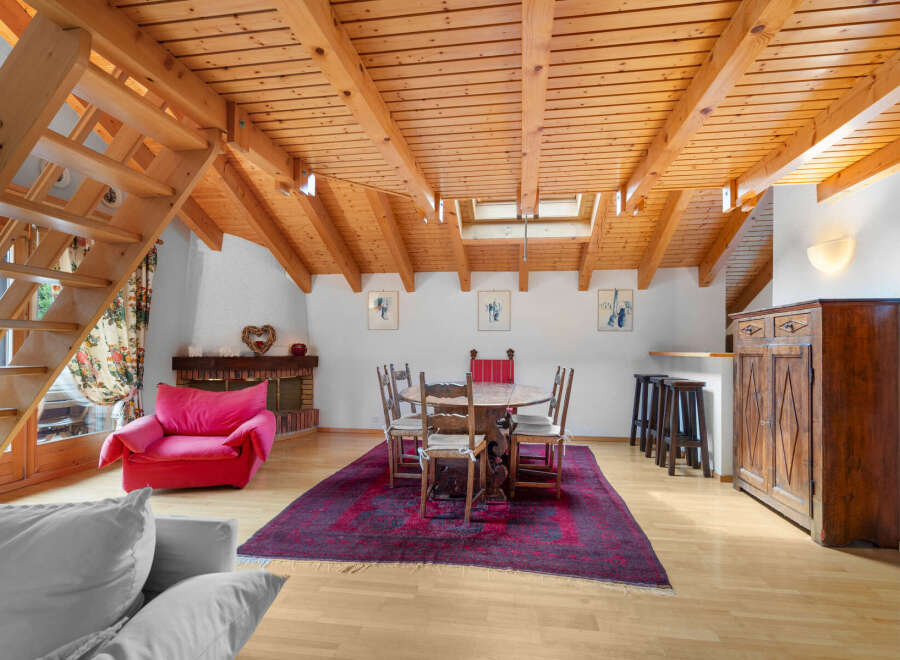 Discover the charm of this unique property featuring a cozy living space with a striking wooden ceiling.