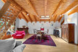 Discover the charm of this unique property featuring a cozy living space with a striking wooden ceiling.