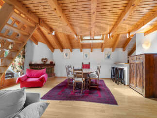 Discover the charm of this unique property featuring a cozy living space with a striking wooden ceiling.