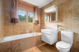 This stunning bathroom boasts a luxurious design with elegant tile work and a bright, airy feel.