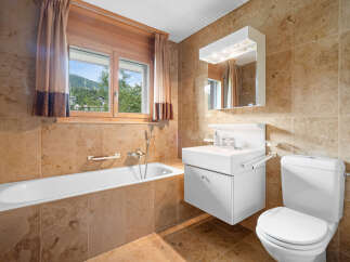 This stunning bathroom boasts a luxurious design with elegant tile work and a bright, airy feel.