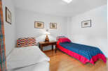 This charming bedroom features two single beds, perfect for guests or family members.