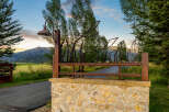 Discover the charm of this stunning property, featuring a beautifully crafted stone entrance and a unique metal gate design.