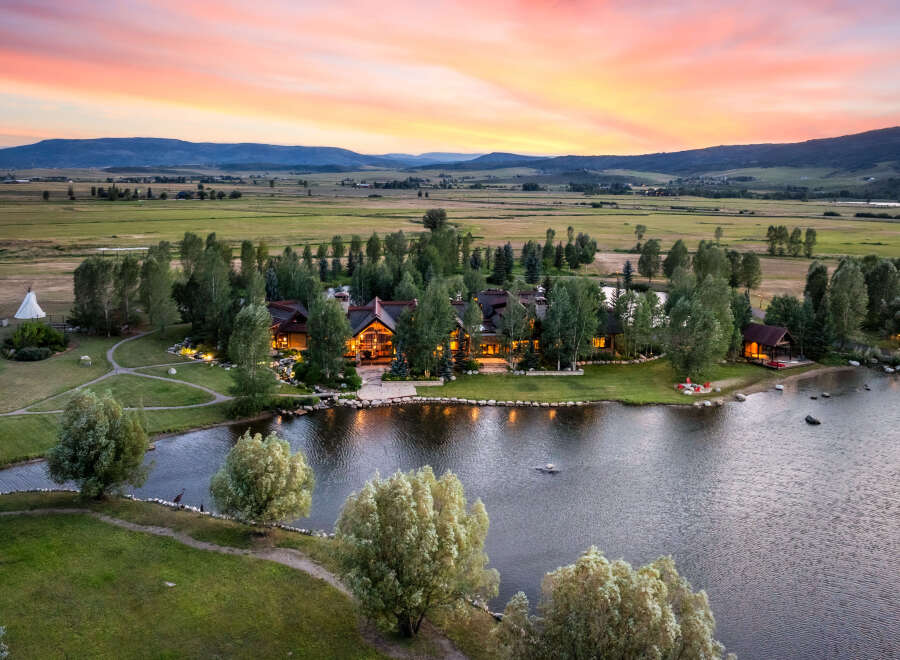 Experience luxury living in this stunning estate, boasting a picturesque lake and lush green surroundings.
