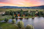 Experience luxury living in this stunning estate, boasting a picturesque lake and lush green surroundings.
