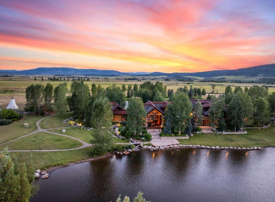 Experience luxury living in this stunning estate, featuring a grand residence nestled amidst a picturesque landscape.