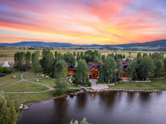 Experience luxury living in this stunning estate, featuring a grand residence nestled amidst a picturesque landscape.